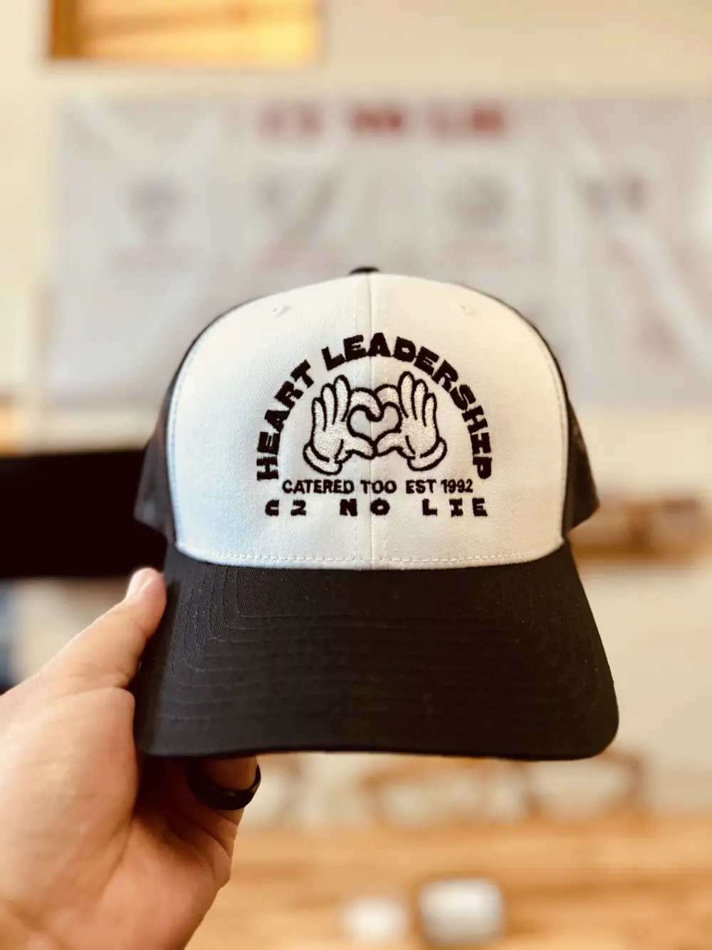 Trucker hat with an embroidered Catered Too logo