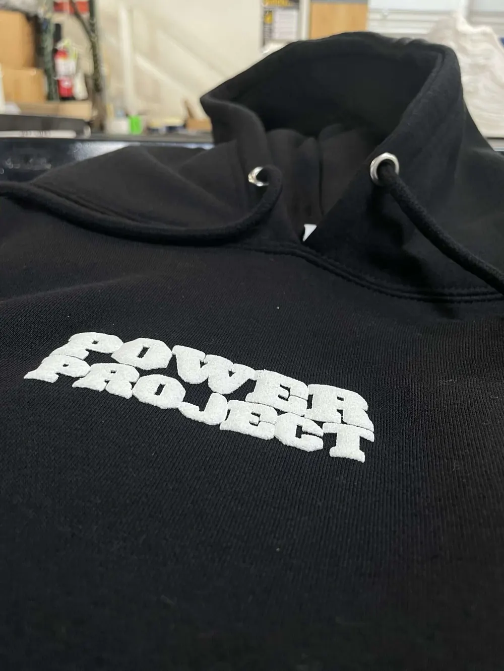 Black hoodie with Power Project in white 3D puff print